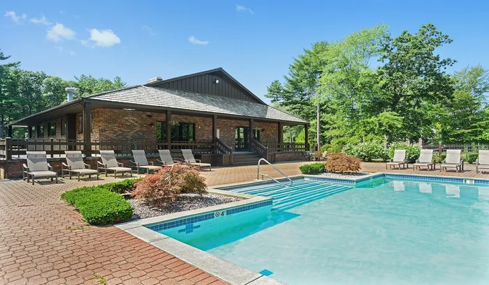 The seasonal swimming pool is surrounded by lush landscaping and comfortable cabanas, delivering a vacation feel right at home. | The Royal Crest | Apartment in North Andover, MA