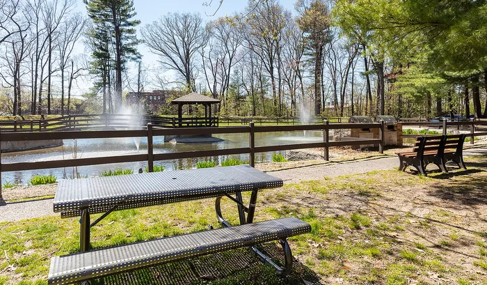 Serene park setting with a picturesque pond, elegant fountain, shaded gazebo, and inviting picnic area.| The Royal Crest | Apartment in North Andover, MA