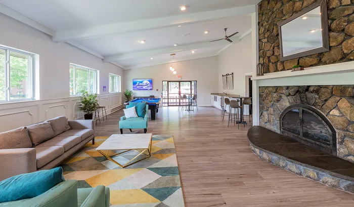 Spacious and inviting communal living area with modern furnishings, cozy fireplace, and entertainment facilities, perfect for relaxation and social gatherings.| The Royal Crest | Apartment in North Andover, MA