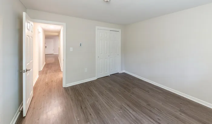 Bright, spacious room with elegant wood flooring and ample storage, offering a modern and welcoming atmosphere.Your spacious kitchen offers generous square footage with room for multiple people and all your cooking essentials. | The Royal Crest | Apartment in,North Andover MA