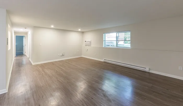 Bright and spacious living area with elegant hardwood floors and large window for natural light.Your spacious kitchen offers generous square footage with room for multiple people and all your cooking essentials. | The Royal Crest | Apartment in,North Andover MA