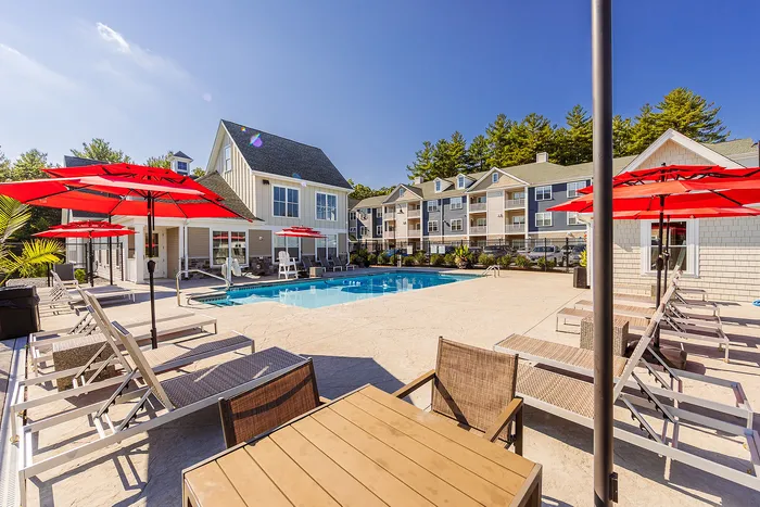 Dive into relaxation in our sparkling swimming pool surrounded by premium deck furniture and refreshing shade structures. | Mill & 3 Apartments | Mill & 3 Apartments Apartments