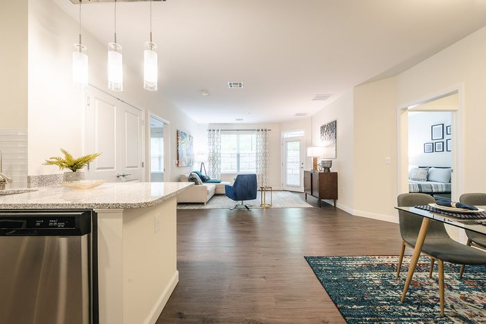 The pleasant living room creates a warm and comfortable atmosphere perfect for daily relaxation. | Mill & 3 Apartments | Apartment in Chelmsford, MA