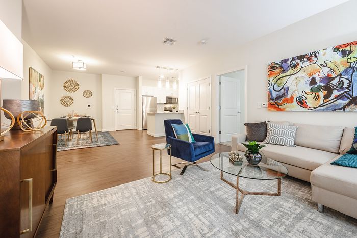This spacious living room offers plenty of room for relaxation and entertaining with flexible layout options. | Mill & 3 Apartments |