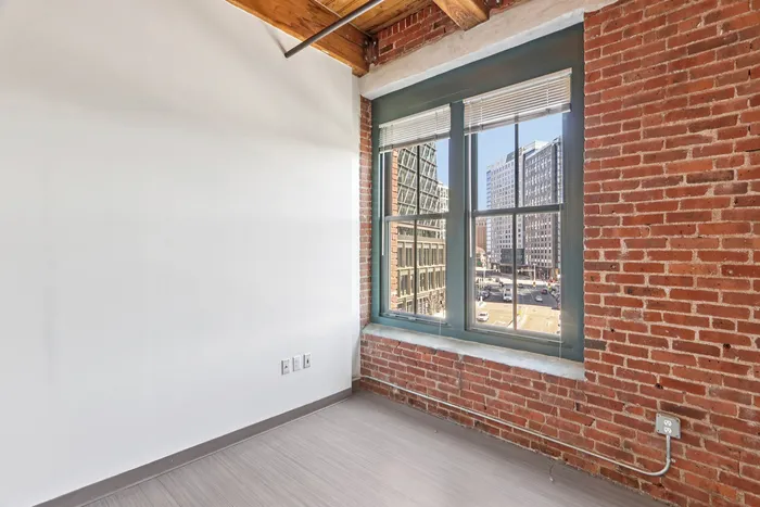 The well-proportioned living room offers versatile space for relaxation, entertainment, and personal expression. | 381 Congress Lofts | Apartment in, Boston MA