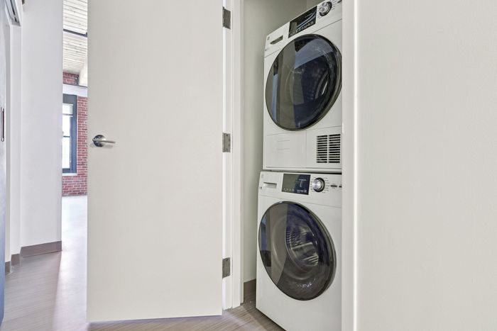 Take care of your laundry needs with our convenient on-site facilities featuring front-loading washers and dryers. Clean clothes, hassle-free. | 381 Congress Lofts | Boston Apartments