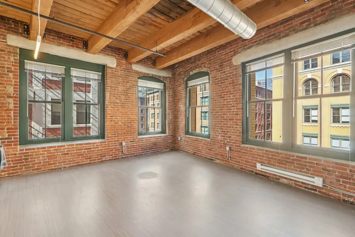 The well-proportioned living room offers versatile space for relaxation, entertainment, and personal expression. | 381 Congress Lofts | Apartment in, Boston MA