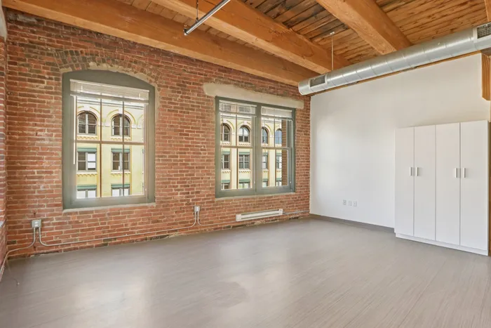 The open living area provides flexible space that adapts to your changing needs throughout the day. | 381 Congress Lofts | Boston Apartments
