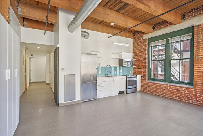 Your spacious kitchen offers generous square footage with room for multiple people and all your cooking essentials. | 381 Congress Lofts | Apartment in, Boston MA