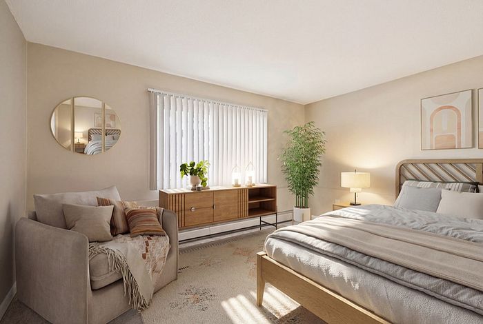 Cozy and elegant bedroom with warm lighting, featuring a plush armchair, sleek wooden furniture, and a lush potted plant for a serene ambiance.