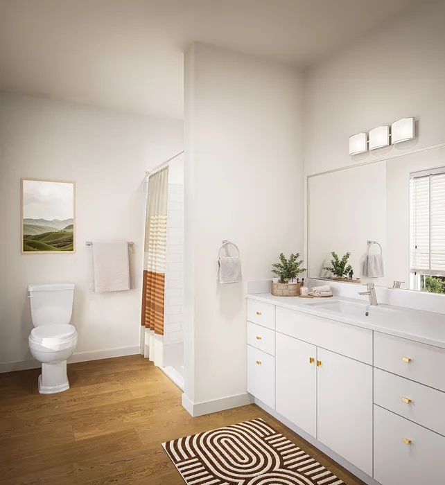 Elegant bathroom with modern fixtures, warm wood flooring, and stylish decor for a relaxing space.