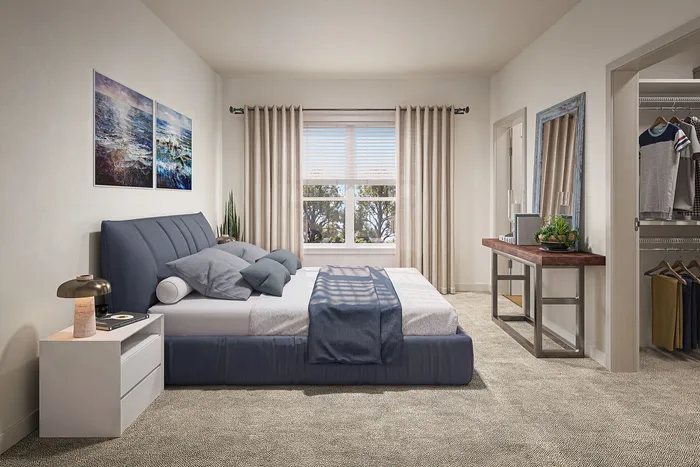 Elegant bedroom with plush carpet, stylish bedding, and a modern side table, featuring natural light through a large window and a spacious walk-in closet.