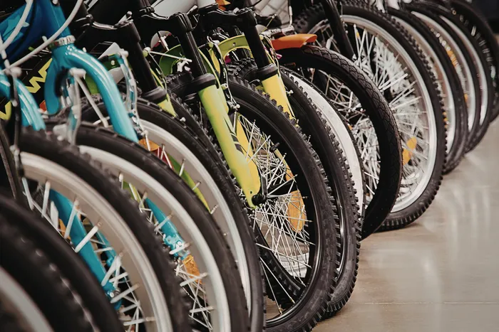 Vibrant display of colorful bicycles lined up in a showroom, showcasing variety and style.