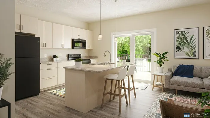 Bright and modern open-plan kitchen and living area with sleek appliances, island seating, and large glass doors leading to a lush green view.