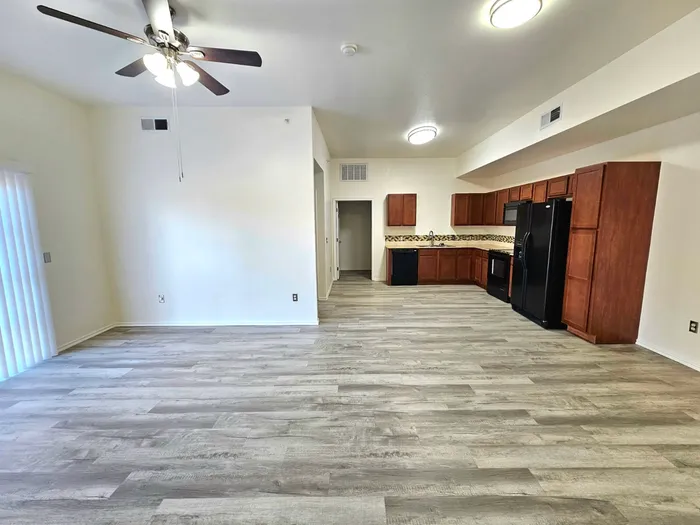 Inviting open-concept apartment with modern kitchen, sleek flooring, and abundant natural light.