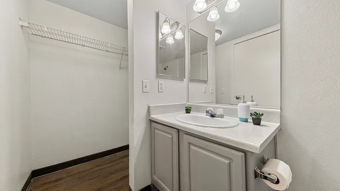 Modern bathroom with sleek fixtures, large mirror, and stylish countertop.