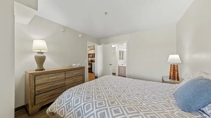 Inviting bedroom with modern decor, soft lighting, and stylish furnishings.