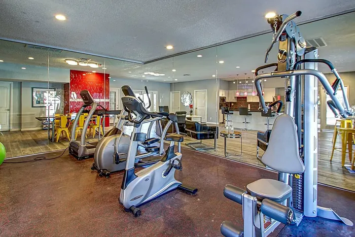 Modern fitness center with exercise machines and a vibrant interior design.