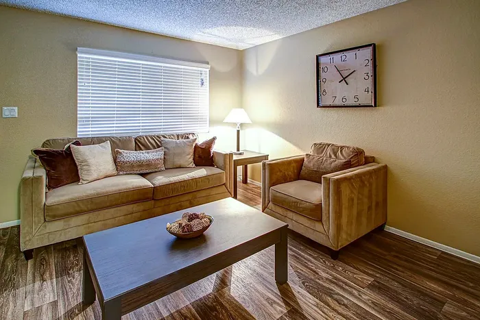 Inviting living room with plush sofa, armchair, stylish coffee table, and elegant decor.