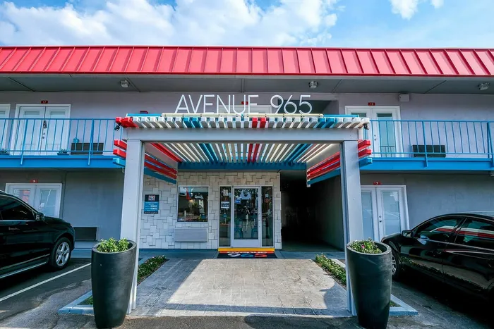 Vibrant entrance of Avenue 965 with modern design and colorful accents.
