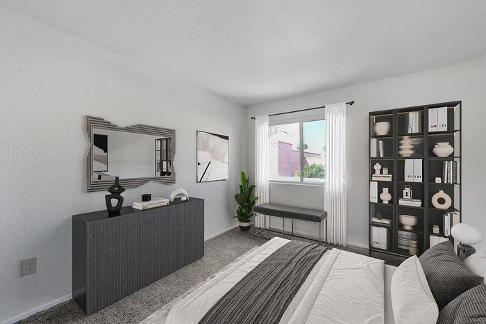 Modern bedroom with stylish decor, featuring a comfortable bed, large window, a sleek bookcase, and decorative accents.