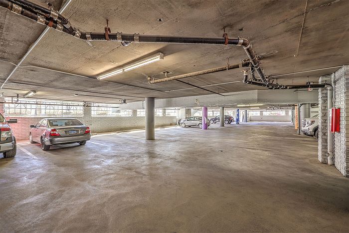 Spacious, well-lit underground parking garage with ample parking spaces, modern infrastructure, and easy access for vehicles.