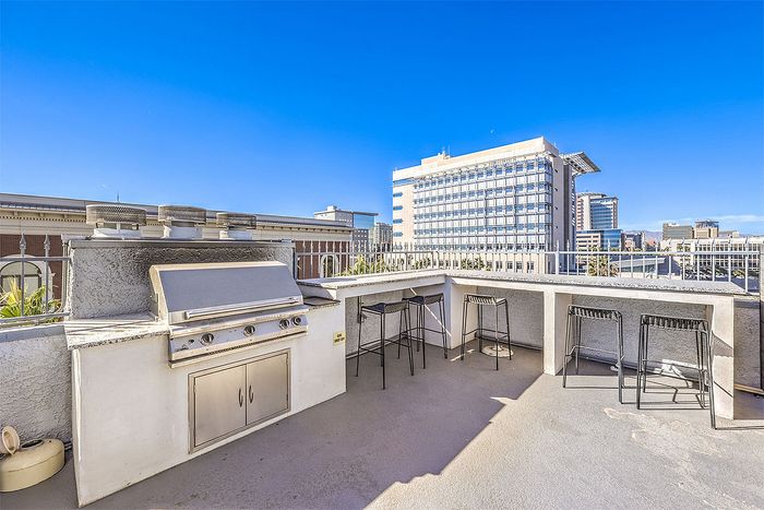 Chic rooftop terrace with built-in BBQ grill, offering stunning city views and perfect space for entertaining.