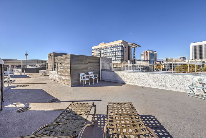 Expansive rooftop terrace with city skyline views and comfortable seating for relaxation and entertainment.