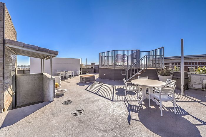 Expansive rooftop terrace with stylish seating, ample sunshine, and stunning city views ideal for relaxation and entertaining.
