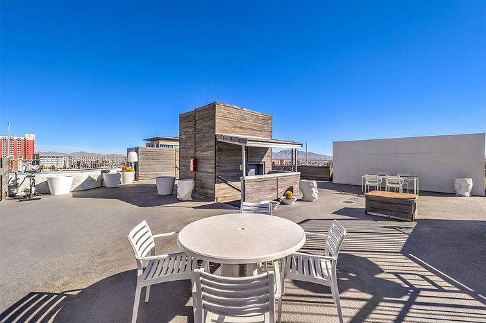Chic rooftop terrace with modern seating and panoramic city views, perfect for outdoor entertaining.