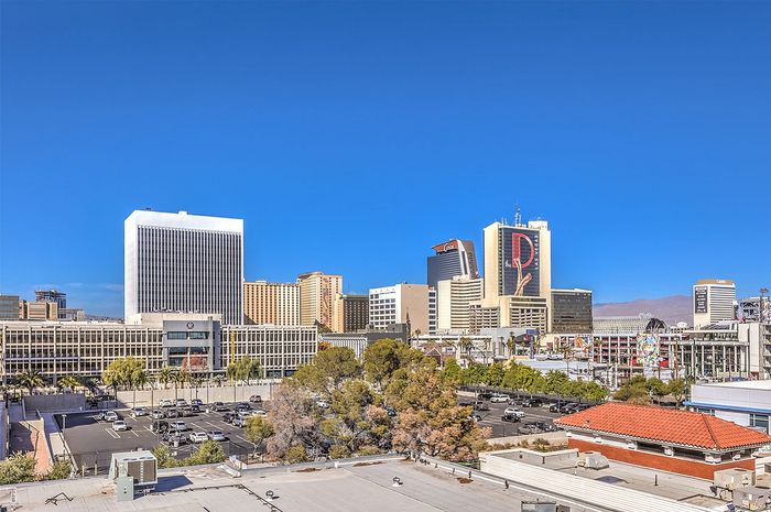 Vibrant city skyline with modern skyscrapers under a clear blue sky, showcasing the dynamic urban landscape.