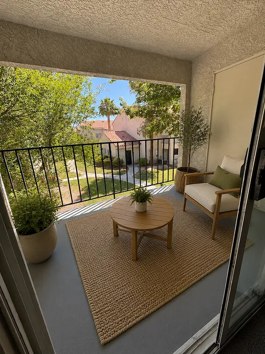 Charming balcony with cozy seating, lush greenery, and serene views, creating a perfect outdoor retreat.