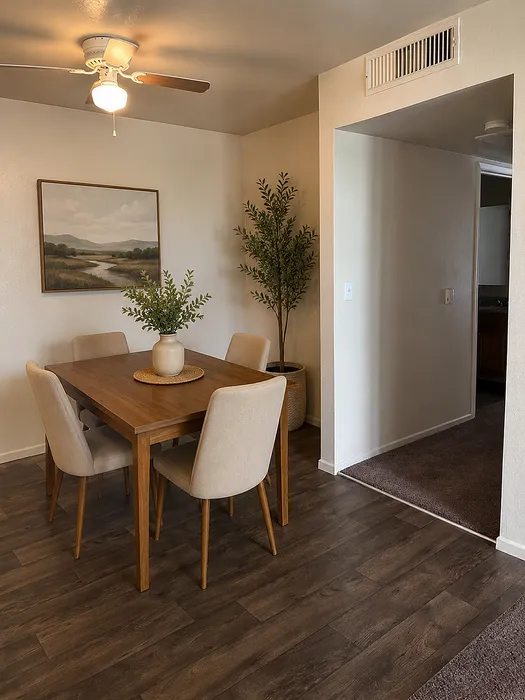 Charming dining area with elegant wooden table, stylish chairs, and serene wall art under warm ceiling lighting.
