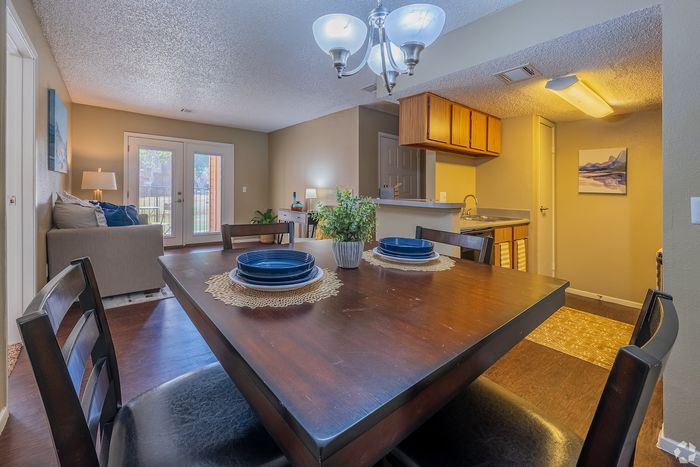 Inviting open-plan living space featuring a cozy dining area, stylish kitchen, and well-lit lounge with garden access.