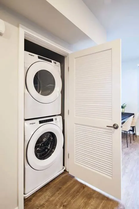 Full size stackable washer and dryer in closet  in a Modera Berkeley, CA apartment.