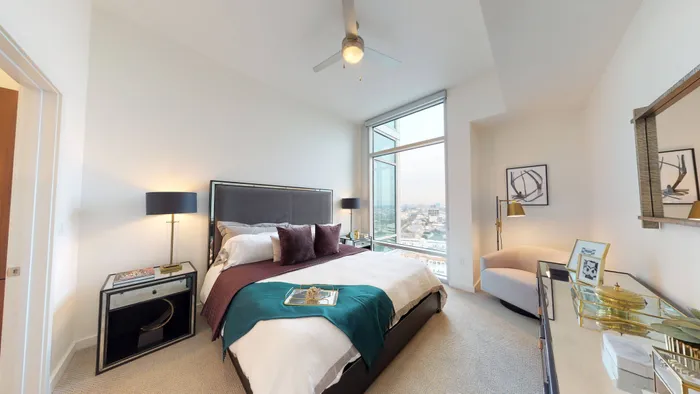 Expansive bedroom with plush wall-to-wall carpeting