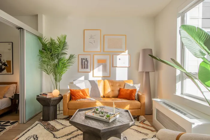 Living room with large window and bright decor in an apartment at Modera River Trail.