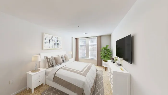 Image of bedroom with tv and windows