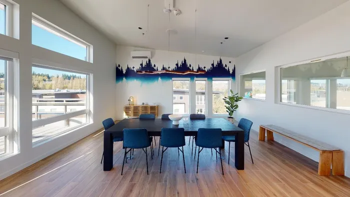 Dining table and seating in common area   at Modera River Trail apartments.