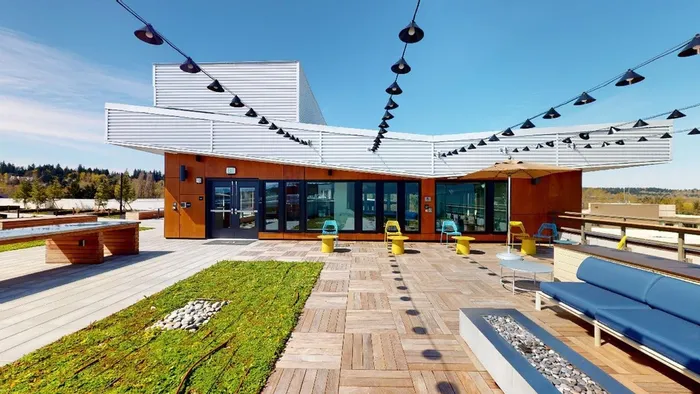 Outdoor common area with fire features, seating and ambiance  at Modera River Trail apartments.
