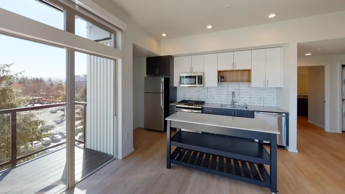 Modern kitchens outfitted with stainless steel appliances and quartz countertops with custom cabinetry. in an apartment at Modera River Trail.