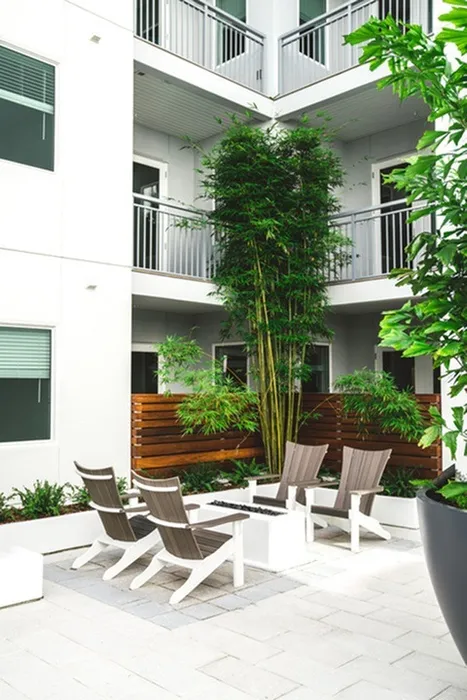 Escape to the Resort-Style Pool Courtyard with Firepit, Outdoor Games & Adjacent Social Lounge with HDTV at Modera Creative Village apartments