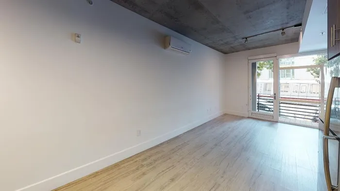 Image of kitchen and living area with large windows