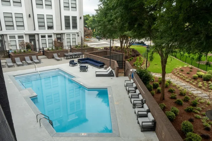 Outdoor pool and seating at Alister Uptown apartments in Charlotte, NC.