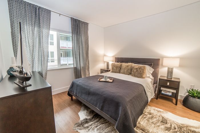 Bedroom with large windows and luxe finishes at the Arroyo Residences in Walnut Creek