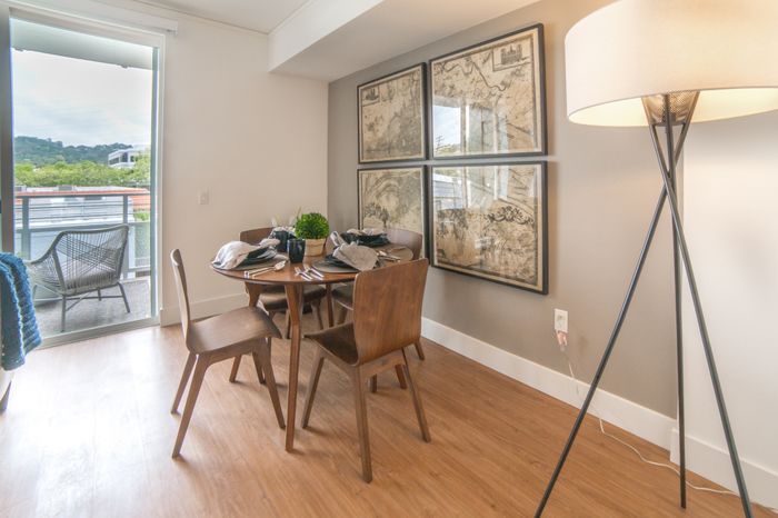 Living room with dining table and Floor-to-Ceiling Windows at the Arroyo Residences in Walnut Creek