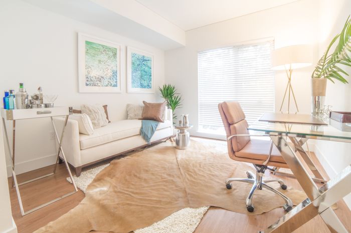 Living room area with large windows at the Arroyo Residences in Walnut Creek