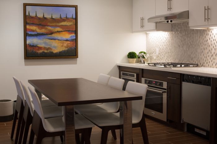 kitchen and dining table area in resident lounge at the arroyo residences in walnut creek