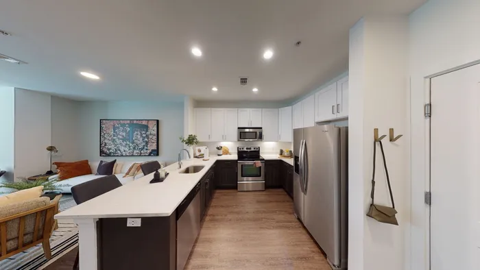 Renovated kitchen at Alister Montclair with two-tone cabinets and quartz counters