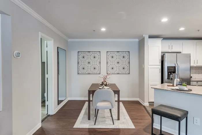 Dining area and ktichen with stainless steel appliances at Alister Galleria apartments houston texas